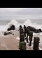 ocean waves breaking on an old wooden pier