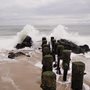 ocean waves breaking on an old wooden pier