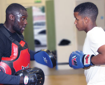 Box Up Crime founder Stephen Addison with a student