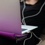 teenage girl sitting on a sofa staring at her open laptop