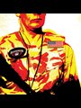 red yellow and black posterized image of an American military contracter with a Blackwater badge