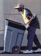 a man pushing a garbage can