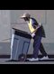 a man pushing a garbage can