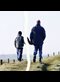 A father and son walking together in a photo that has been ripped apart