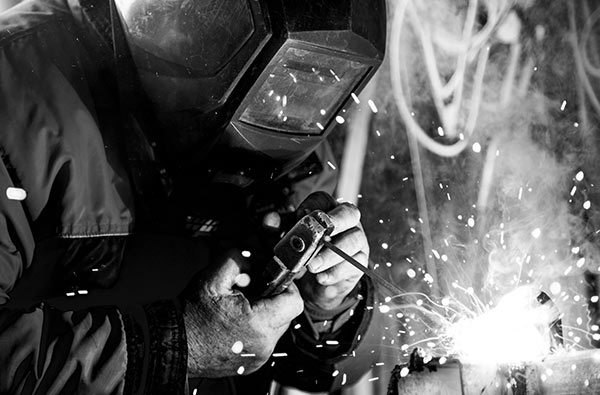 a man in a welders mask working