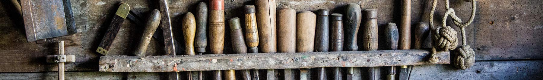 tools hanging on a wall in a workshop