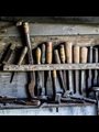 tools hanging on a wall in a workshop