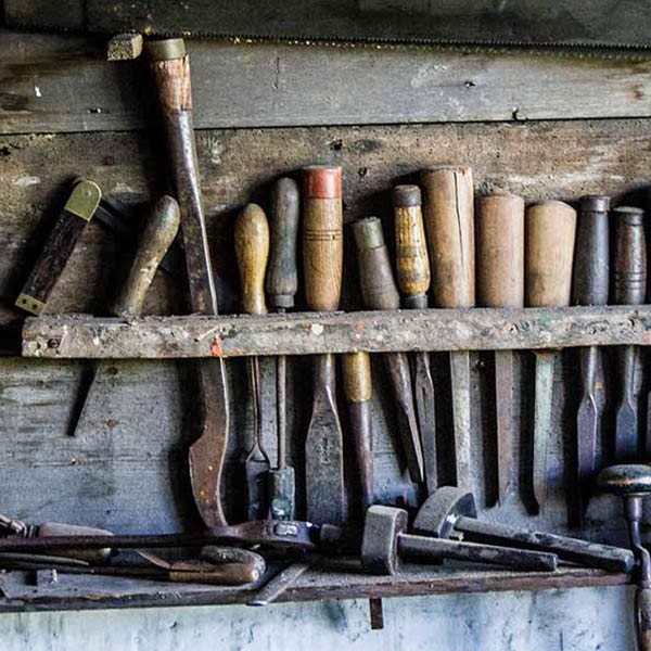 tools hanging on a wall in a workshop