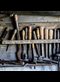 tools hanging on a wall in a workshop