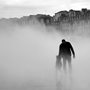 a father and daughter walking in a mist covered street