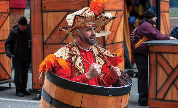 a mummer in a bright red and gold costume
