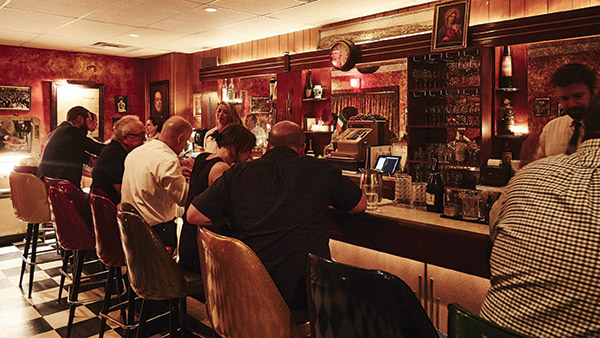 people sitting at a the bar in the Palizzi Club