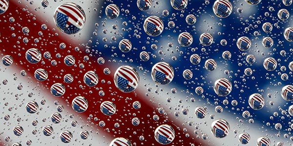 oil and water with an American flag behind