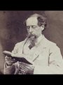 A photo of Charles Dickens reading a book