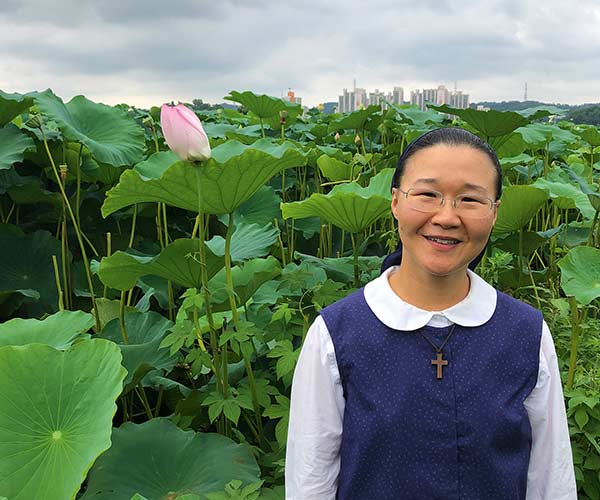 Hyeran Jang in front of a blooming bush near Seoul Korea