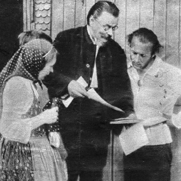 Eberhard Arnold and colleagues looking over a manuscript for typesetting