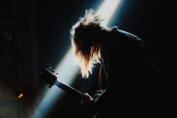 a guitarist playing on a stage