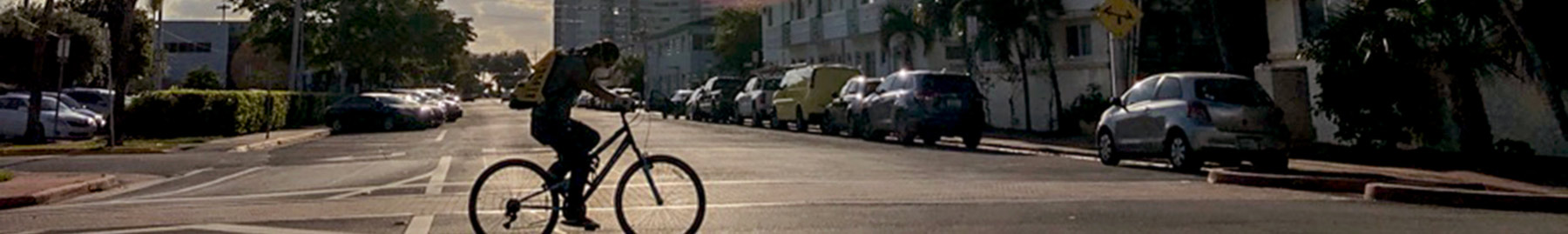 a man riding a bicycle on a deserted street