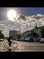 a man riding a bicycle on a deserted street