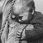 black and white photograph of a little boy hugging his mother