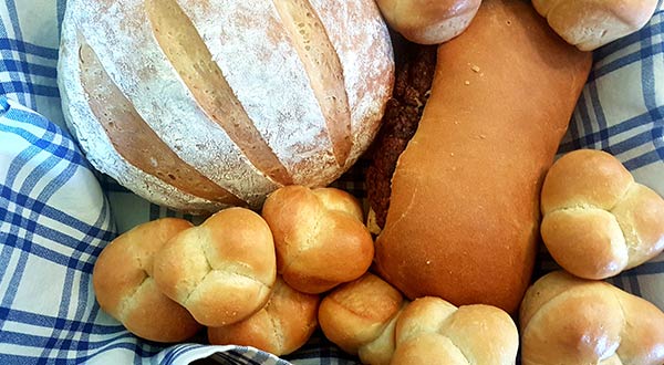 different types of bread on a blue checked cloth