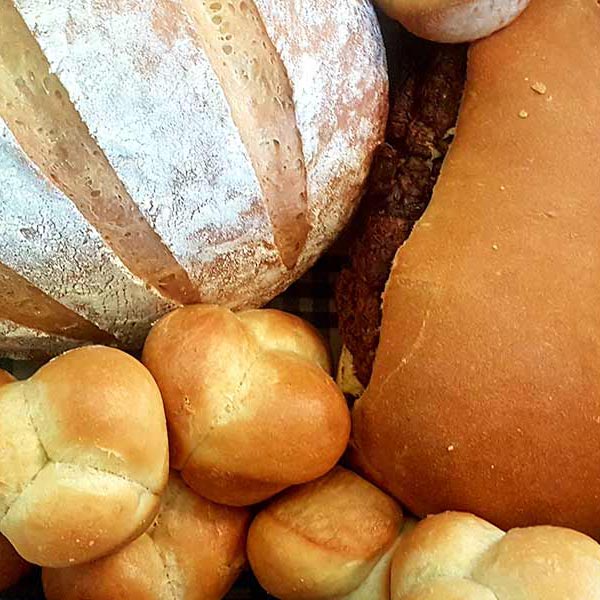 different types of bread on a blue checked cloth