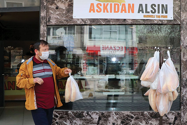 a man giving bread to the poor in Istanbul