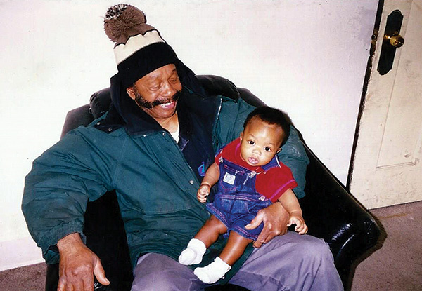 an older man holding a baby boy