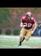 a football player running across a field