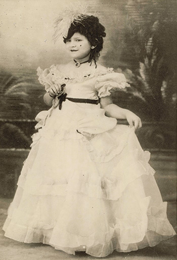 a young girl dressed in a carnival costume, 1938