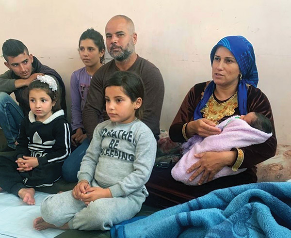 a Syrian family posing for a photo