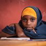 a portrait of a girl sitting at a desk