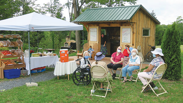 people relaxing near the Coleman Corners farm stand