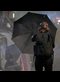 a woman holding a black umbrella