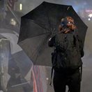 a woman holding a black umbrella