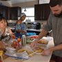 people preparing a meal in a sunny kitchen