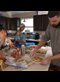 people preparing a meal in a sunny kitchen