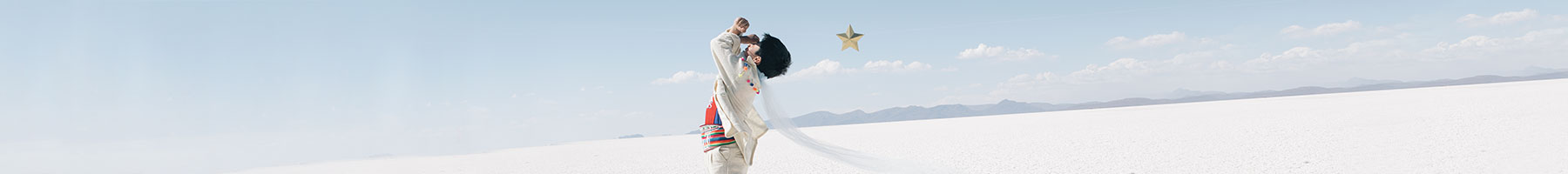 boy in white dancing on a flat white plain: reenactment of an image from The Little Prince