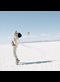 boy in white dancing on a flat white plain: reenactment of an image from The Little Prince