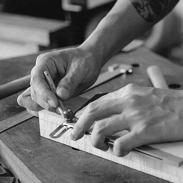 person measuring wood
