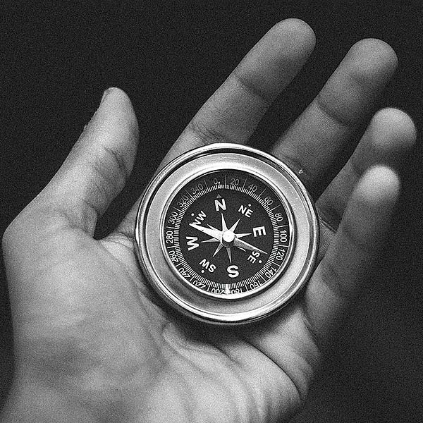 hand holding a compass
