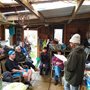 group of people chatting in a garden shed