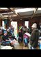 group of people chatting in a garden shed