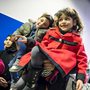 A Syrian father and his children wait in line to have their passports checked at Hanover airport in Germany.