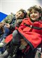 A Syrian father and his children wait in line to have their passports checked at Hanover airport in Germany.