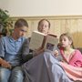 a mother reading a story to two children