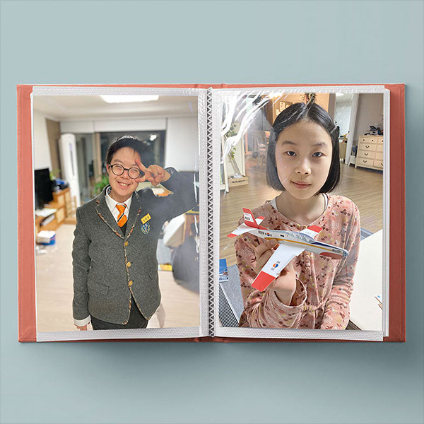 photos of Yusang and Seoyul in a small photo album