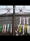 colorful ribbons with Korean writing on them tied on a barbed wire fence