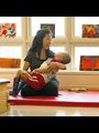 physical therapist holding a child wearing braces in a sunny room
