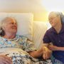 a young woman with Down syndrome sitting beside her elderly mother